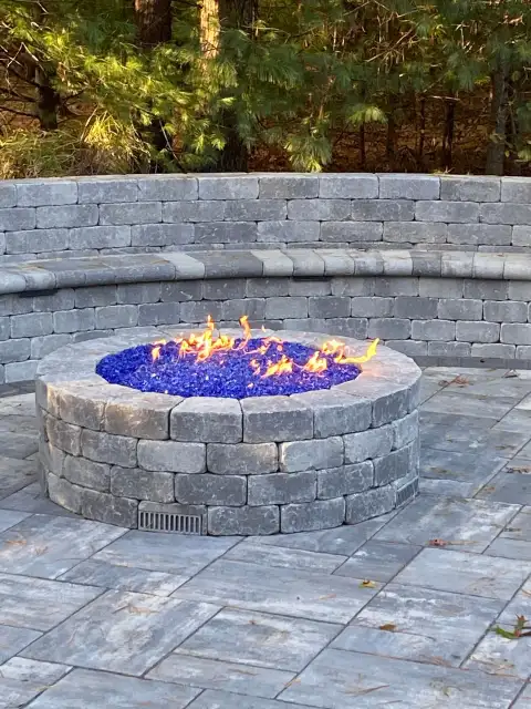 Stone firepit with blue glass flame