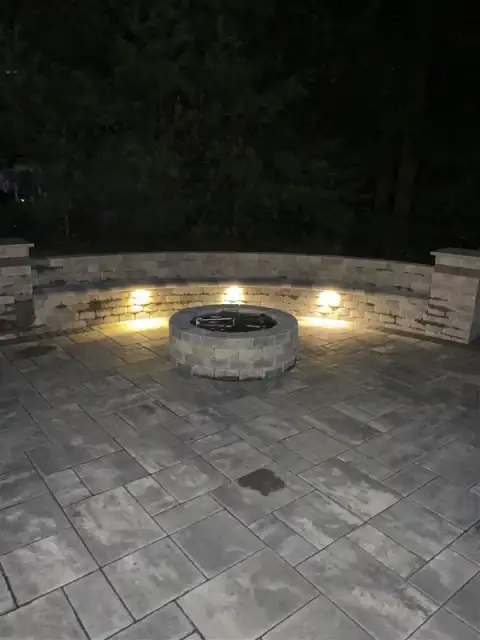 Lit firepit patio at night